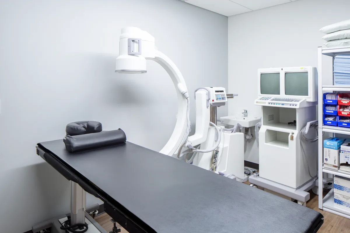 The image-guided procedure suite with its C-arm